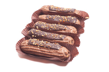 Delicious eclairs with chocolate isolated on white