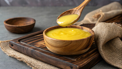 Pure Desi Ghee in Wooden Bowl &ndash; Organic Ghee, Traditional Indian Cooking Ingredient Photography
