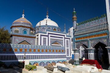 Bhit Shah, Pakistan - 05 December 2025: View of the shrine's blue and white mosaic domes and intricate tile work contrasts sharply against the clear sky, creating a mesmerizing visual symphony.