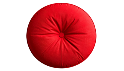 A vibrant, top-down view of a round, red, button-tufted cushion on a stark black background