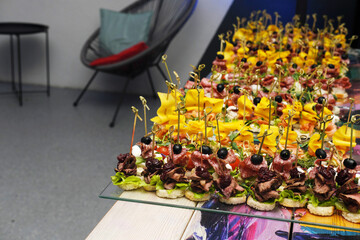 Colorful platter of gourmet appetizers featuring fresh vegetables, meats, and garnishes, beautifully arranged for catering at an upscale event with elegant presentation
