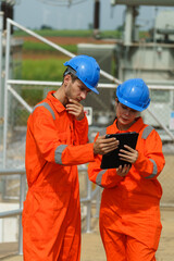 Electrical engineers are checking the operation and power distribution systems within the substation receiving power from the wind farm.