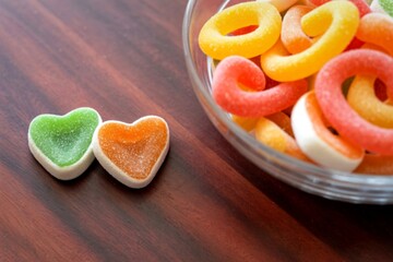 Sweet heart shaped candies and ring candies in a glass bowl