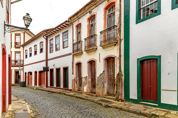 Fototapeta premium Strolling down the street among the colonial houses of the historic city of Ouro Preto