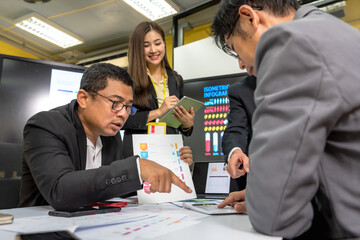 Male and female businesspeople team working together in business meeting with company statistic chart on screen background