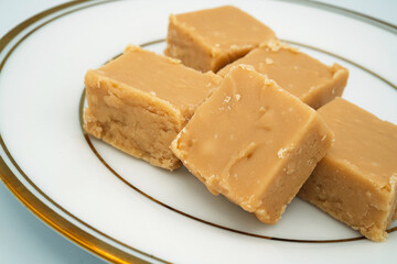 Squares of creamy homemade brown sugar fudge.