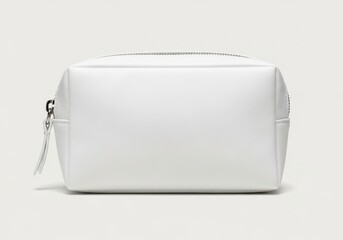 Rectangular white zippered pouch rests on a smooth, light gray background