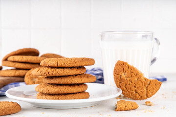 Homemade golden-brown Gingersnap Cookies stack on kitchen table. Traditional american ginger snap cracked biscuit cookies, with milk glass, copy space