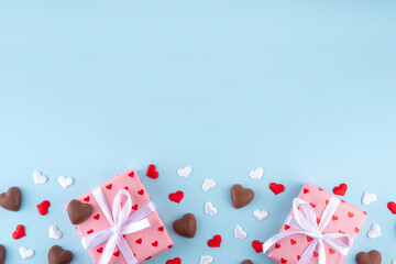 Romantic Valentine day background with hearts, gift boxes, heart-shaped chocolates. St...