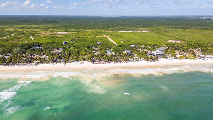 Tulum Beach, Quintana Roo, Mexico, Beautiful beach with palm trees and a clear blue ocean. The beach is empty and the sky is clear