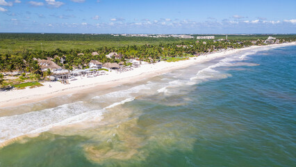 Tulum Beach, Quintana Roo, Mexico, Beautiful beach with a clear blue ocean and a few palm trees. The beach is empty and the water is calm