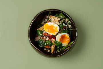 Fresh salad filled with colorful vegetables and two soft-boiled eggs sits in a beautiful bowl. Enjoying this delightful dish makes for a healthy and satisfying meal at any time of day