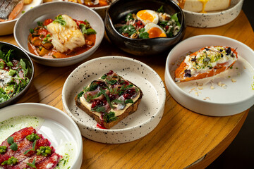 Brightly colored plates are filled with a variety of artistic dishes featuring fresh ingredients. Each bite showcases culinary creativity, making it a perfect feast for food lovers