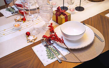 Festive Christmas table setting with decor and gift for. Christmas eve (Cozy atmosphere, elegant interior. Top view.