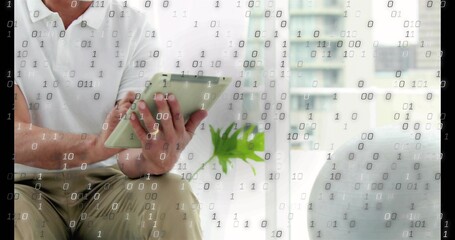 Using tablet, mature man in polo, khaki sitting by glass door, plant binary overlay, copy space