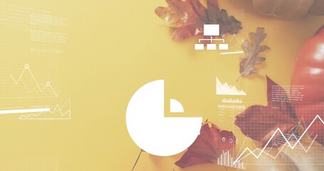 Naklejka premium Displaying white pie-chart centered on mustard tabletop, showing line graphs, oak leaves, pumpkin
