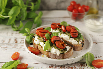 Italian sandwiches with grilled tomatoes, burrata cheese and pesto	