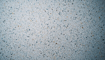 A vibrant macro view of a light gray speckled surface showcasing a consistent pattern of small, multicolored aggregate chips, offering a unique textured background for architectural or graphic design