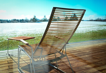 A deck chair on the wooden terrace or balcony in a relaxation hotel resort by winter. 