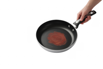 Hand holding frying pan with red substance isolated on a transparent background
