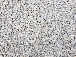 White grey small rocks texture background.