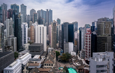 Hong Kong, China, Panoramic view of Tai Kwun, the former Central Police Station, framed by the dense high-rise skyline, showing the contrast between heritage architecture and modern urban development.