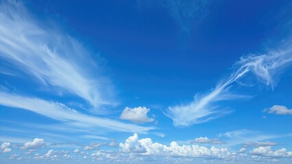 Bright blue sky with white clouds and wispy cirrus clouds, clear weather and sunny day.