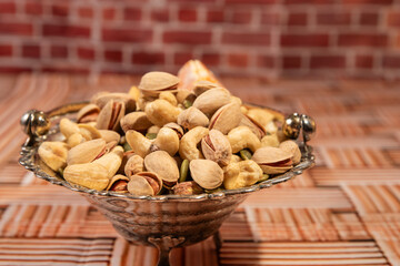 Pistachios, pumpkin seeds and cashews in a vase