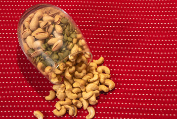 Healthy snacks in a clear vase on a red and white polka dot background
