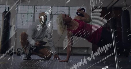 Trainee holding side plank doing kettlebell row or press for fitness coach noting tablet HUD metrics - Powered by Adobe