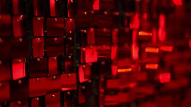 Iridescent red sequins hang on the wall as a beautiful backdrop