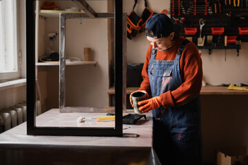 Concept of home improvement renovation. Dedicated woman worker opening paint preparing materials...