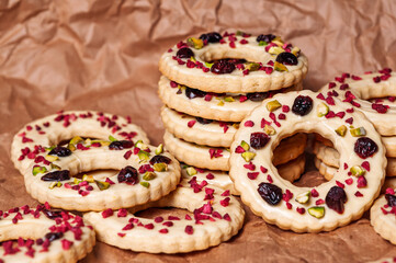Delicious ring cookies with white icing, cranberries, and pistachios