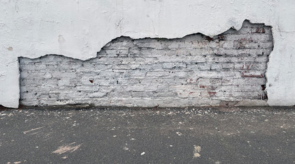 Old brick white wall and asphalt floor