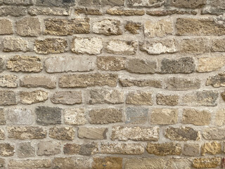 Background Ancient wall of brown stone closeup