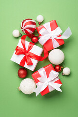 Christmas gift box and holiday decorations at green background. Boxing day. Flat lay.