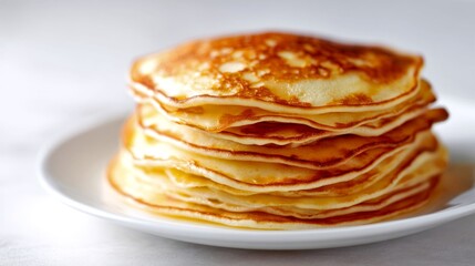 A delicious stack of golden pancakes sits on a clean white plate. The fluffy texture is inviting and perfect for breakfast. Ideal for food photography. AI