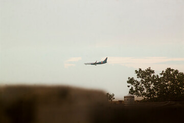 Obraz premium Indonesian Police Passenger Aircraft Flying low from afar on a bright clear skies