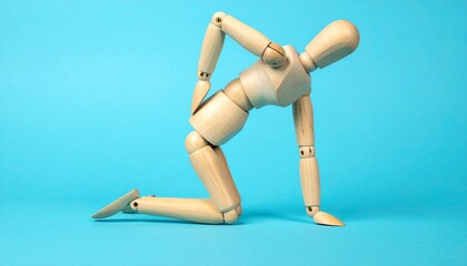Wooden Art Mannequin Kneeling and Holding Back in Pain Against a Solid Blue Background