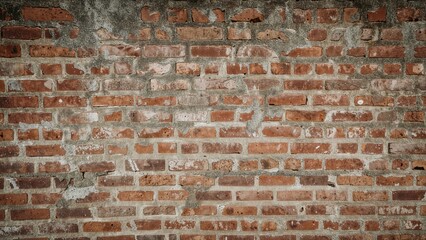 Brick wall background with weathered red bricks and mortar, rustic and textured surface.
