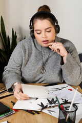 Creative expression and artistic exploration by a beautiful plus size woman in a cozy space © LIGHTFIELD STUDIOS