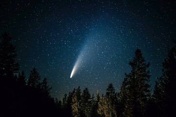 Fototapeta premium glowing comet tail streaming across a dark starry sky