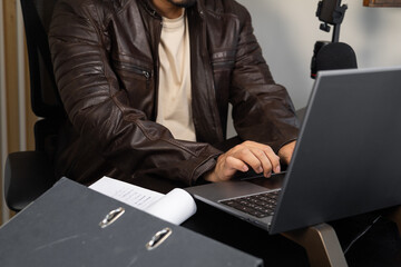 Professional Man Working on Laptop with Desk Microphone
