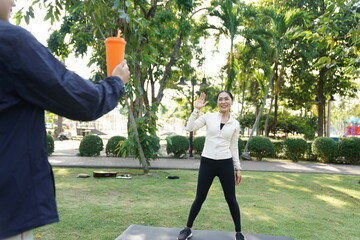 Asian women engage in recreational activities in a park.