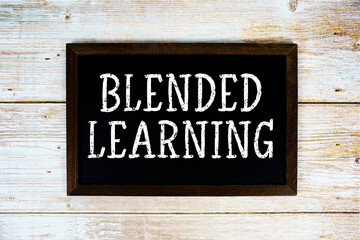 Blended Learning text written on blackboard flat lay on wooden background