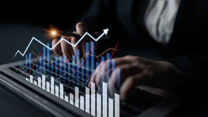 A business professional focuses on financial data through a laptop, surrounded by dynamic graphs representing growth trends in a modern workspace. Scalp