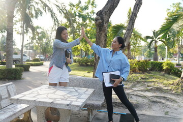 An Asian freelance woman arranges an off-site work meeting with a friend.
