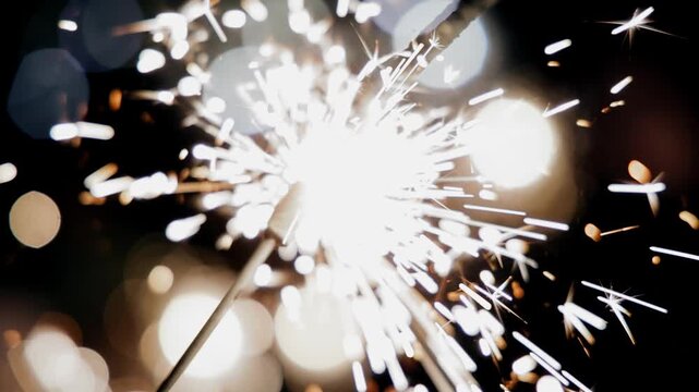Sparks fly from sparklers in different directions. Close-up shooting