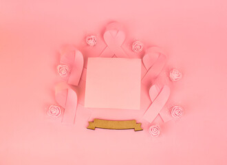 A breast cancer support display with ribbons and flowers surrounding a blank area inviting...
