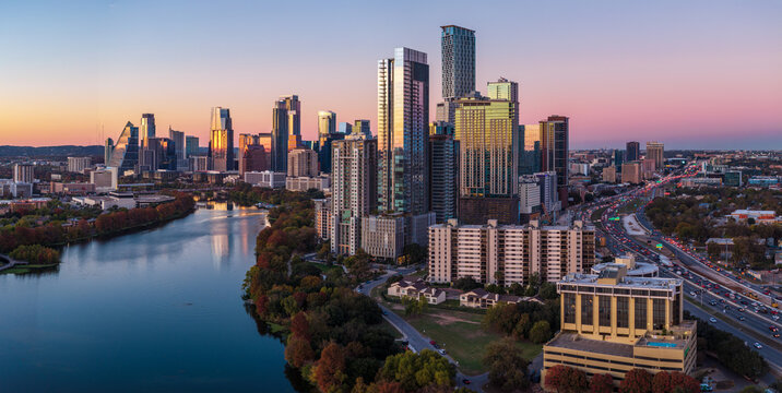 Aerial panoramic skyline of Austin Texas from the east at dusk or sunset in December 2025 with fall colors and clear sky